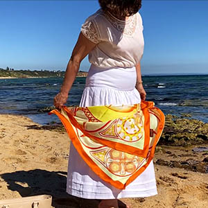 She caught a Sun-spot of vital energies with amber gold splash of colours of the Everlasting life silk scarf by PSICHORA.