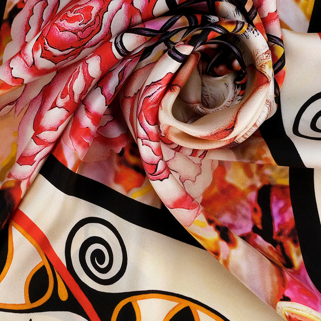 The closeup view of The Beginning 100% silk scarf of soft pink, golden amber & bold strikes of rich brown & woven in Trypillian symbols.