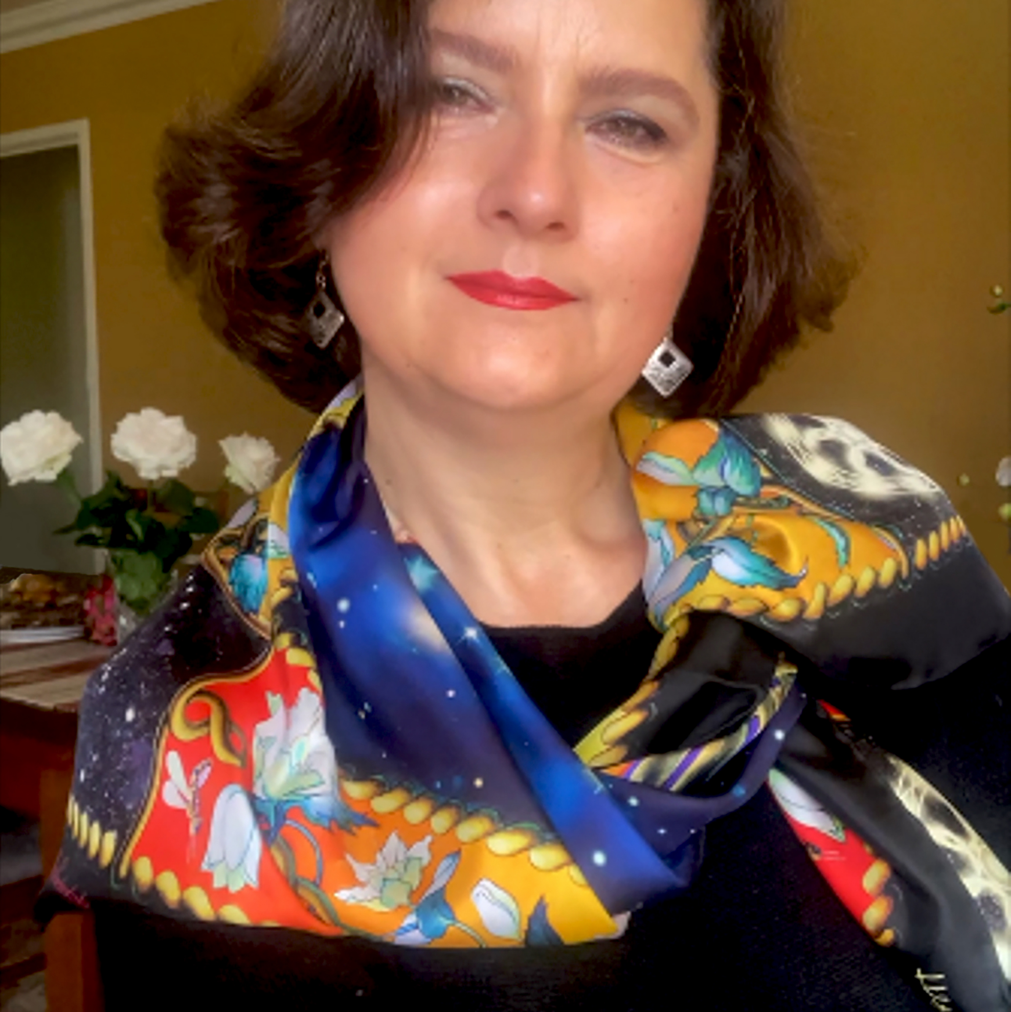 Stand out in the Creation designer silk scarf. Its black, red, amber, golden, and blue colours, Celtic braids and blooming branches blended together, create a splendidly rich composition. Made in Italy, this PSICHORA piece carries an aura of cosmic grandeur, adding a sense of deep space-inspired elegance to your look.