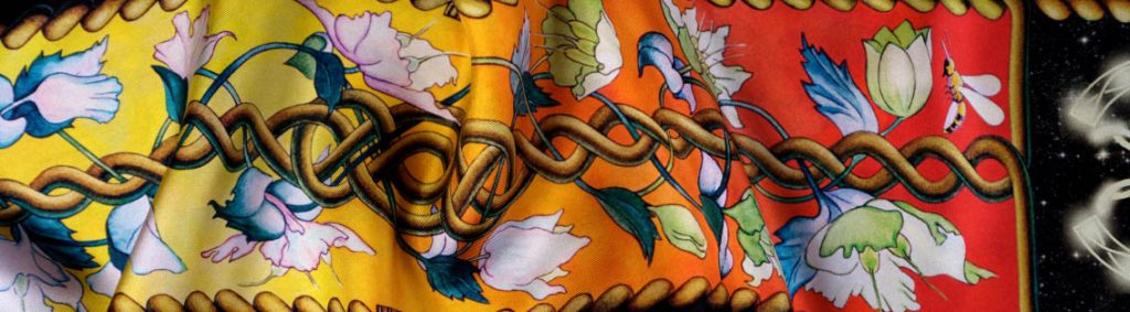 The Creation luxury silk scarf 90cm in black, red, amber golden. Closeup.