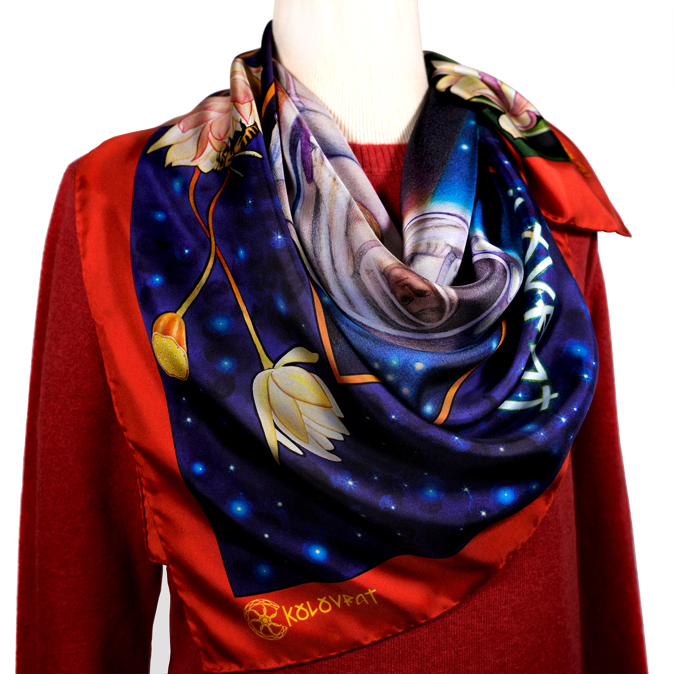 The striking Orion pure silk scarf combines deep navy blue with vibrant red, emerald leaves, and flowers in a mysterious composition, complemented by lotus flowers. Designed in Australia and made in Italy, this PSICHORA scarf captures the beauty of the night summer sky, embracing earthy opulence of shapes and rich colours.