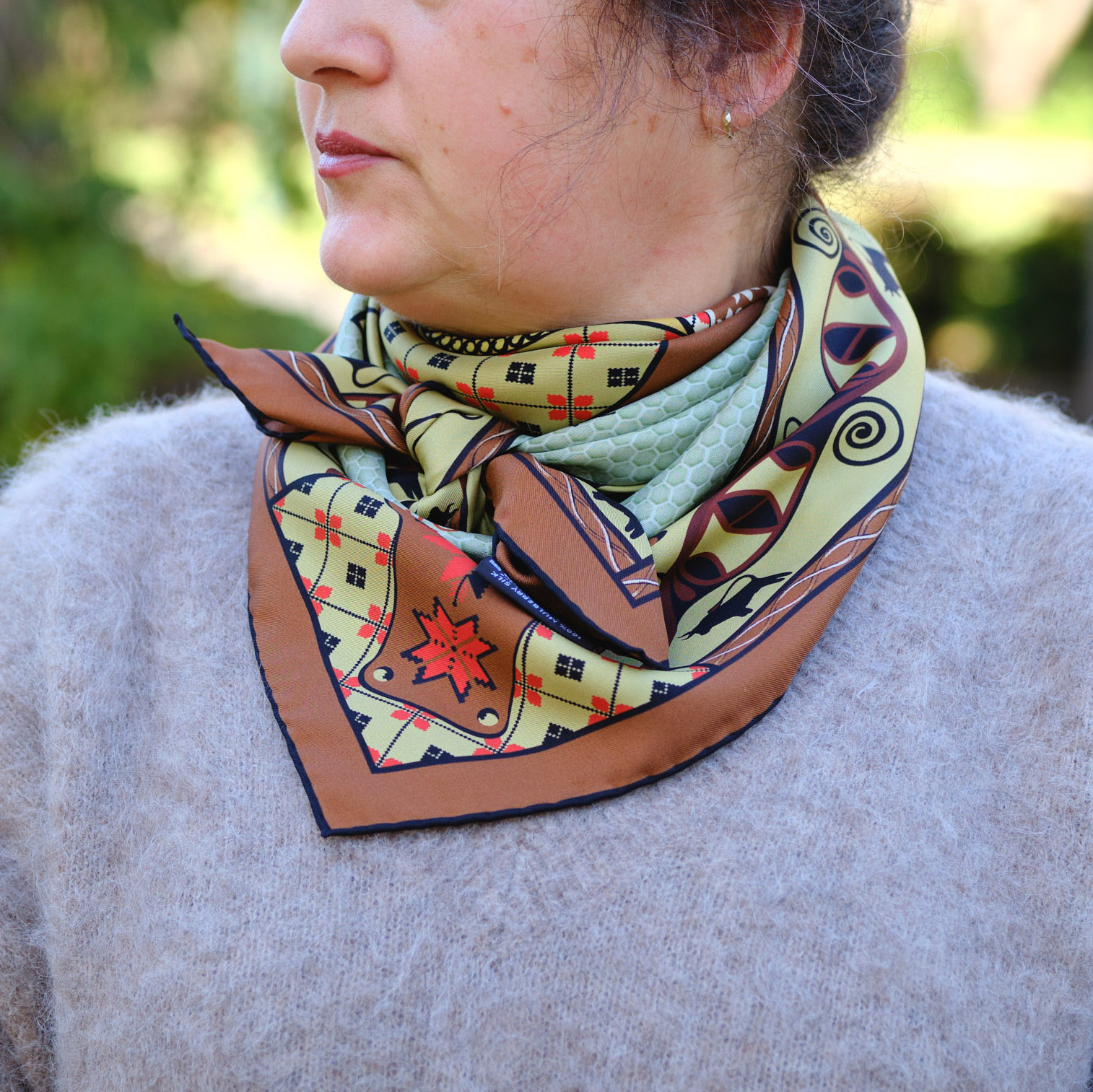 Envelop yourself in the vibes of the Talisman terracotta olive silk scarf. Designed in Australia and handcrafted in Italy, this luxurious accessory fosters loving harmony and inner stability. Experience the protective power of Talisman, enhanced by the energy of the Trypillia DNA symbols.