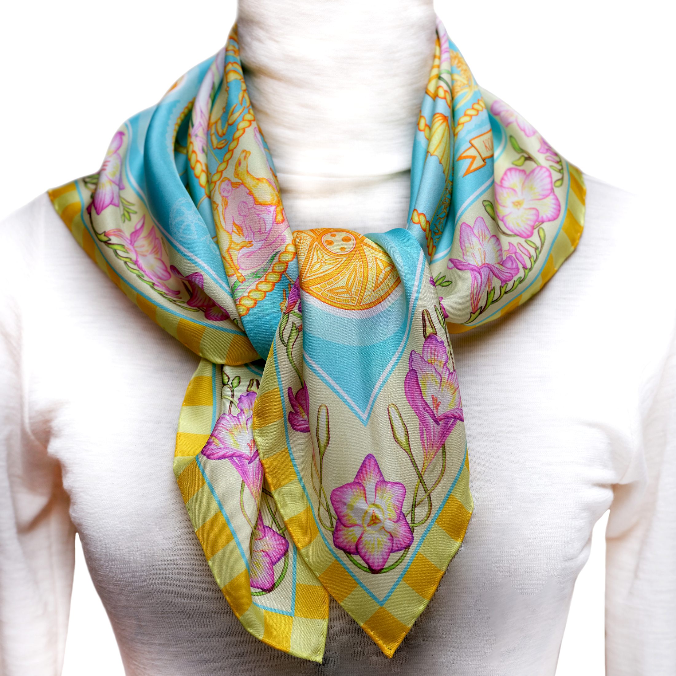 Designed in Australia, the Turquoise Sky pure silk scarf of lighter 52gsm weight combines golden wheals of celestial imagery with pink florals and telling imagery embraced with turquoise blue sunlit sky. Made in Italy, this PSICHORA piece brings naturally splendid sky‑inspired elegance to your look.